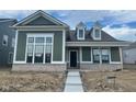 Charming single-Gathering home with an inviting craftsman-style front porch and beautiful green siding at 15352 Cardonia Rd, Fishers, IN 46037