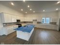 Bright, spacious kitchen featuring white cabinets, a large center island, and stainless steel appliances at 15352 Cardonia Rd, Fishers, IN 46037