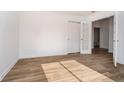 A spacious bedroom features stylish flooring and a doorway to an adjoining room at 202 Asbury Dr, Anderson, IN 46013