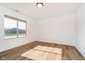 Bright bedroom with large window and light-colored floors providing ample natural light at 202 Asbury Dr, Anderson, IN 46013