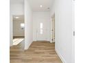 Inviting entryway with a white front door and beautiful hard surface flooring at 202 Asbury Dr, Anderson, IN 46013