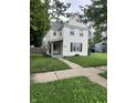 Traditional two-story home featuring a quaint front porch and well-maintained lawn at 2244 Lafayette St, Anderson, IN 46012