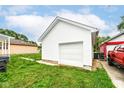 Detached one-car garage featuring white siding and an overhead door, adding functionality to the property at 2413 Fowler St, Anderson, IN 46012