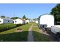 Expansive backyard with multiple storage sheds, a fire pit, and ample space for outdoor activities at 2616 Jackson St, Anderson, IN 46016