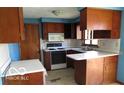Functional kitchen features wood cabinets, a white countertop, and essential appliances at 311 Fall Creek Dr, Anderson, IN 46013
