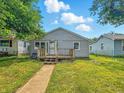 View of the home's front exterior with a small porch and a well-manicured lawn at 3251 Mars Hill St, Indianapolis, IN 46221