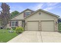 Well-maintained two-story home featuring a two-car garage, brick accents, and neat landscaping at 3287 Buckmoor Pkwy, Greenwood, IN 46143