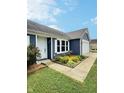 Charming blue home with a well-manicured lawn and colorful flower bed at 3341 Orchard Valley Dr, Columbus, IN 47203