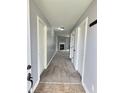 Inviting hallway with neutral paint, multiple doors, and a view of the fireplace at 3341 Orchard Valley Dr, Columbus, IN 47203