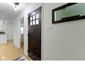 Light and bright foyer with hardwood floors, front door, coat rack, and mirror at 3841 Meridee Dr, Indianapolis, IN 46237