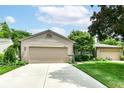 Charming home with a two car garage, concrete driveway, and lush green lawn at 392 Sandbrook Dr, Noblesville, IN 46062