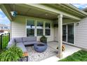Inviting covered patio with comfortable seating around a modern fire pit, ideal for outdoor entertaining at 4250 Blackford Rd, Bargersville, IN 46106
