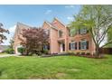 Charming brick home with black shutters, large windows and manicured landscaping at 427 Quincy Pl, Westfield, IN 46074