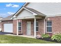 Cozy brick home with covered entry, lush lawn, and a neat landscape at 4295 Washington Blvd, Plainfield, IN 46168