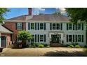 Inviting two-story home with brick and light gray siding, a well-manicured lawn, and a charming front entrance at 4443 Mallard Pt, Columbus, IN 47201