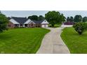 Charming brick home with attached garage, long driveway, and barn set on expansive lawn and beautiful landscaping at 4670 N 600 E, Franklin, IN 46131