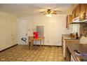 Outdated kitchen featuring wood cabinets, a laminate countertop, and patterned linoleum flooring at 515 Hawthorne Ave, Anderson, IN 46011