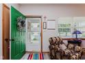 Cozy entryway with a vibrant green door, patterned chair, and lots of natural light at 5515 Gateridge Ln, Indianapolis, IN 46237