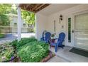 Charming covered front porch with seating, flowers and a 'welcome' sign at 6920 Wesley Ct, Indianapolis, IN 46220