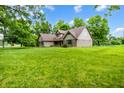 A lovely home with a well-kept lawn and mature trees creating a serene and private setting at 7533 Deerfield Dr, Greenfield, IN 46140