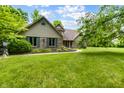 Beautiful home with brick accents, complemented by green shutters and a well-maintained lawn at 7533 Deerfield Dr, Greenfield, IN 46140
