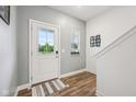 Light-filled entryway with wood-look flooring, a white front door, and a view of the outdoors at 7834 Hillway Dr, Camby, IN 46113