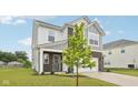 Two-story home with gray and white siding, brick accents, well-manicured lawn and landscaping at 7834 Hillway Dr, Camby, IN 46113