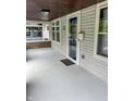 Covered front porch featuring a glass front door, neutral paint, and a ceiling light at 810 N Bosart Ave, Indianapolis, IN 46201