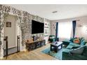 Inviting living room with an entertainment center, plush sofa, and bright accents at 818 Vasbinder Dr, Chesterfield, IN 46017