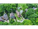 Overhead view of home, green lawns, mature trees, and neighborhood layout at 838 Woodruff Place West Dr, Indianapolis, IN 46201