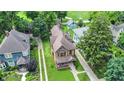 Aerial view showcasing the property, its landscaping, and surrounding neighborhood at 838 Woodruff Place West Dr, Indianapolis, IN 46201