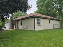 Side view of home with siding and a brick chimney at 8433 Fairwind Ct, Indianapolis, IN 46256