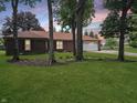 Brick ranch style home with well maintained lawn and mature trees at 8433 Fairwind Ct, Indianapolis, IN 46256