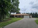 Brick ranch style home with attached garage and long driveway at 8433 Fairwind Ct, Indianapolis, IN 46256