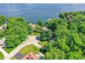 Beautiful lakefront property surrounded by lush greenery and mature trees, showcasing its serene setting at 8924 Stormhaven Ct, Indianapolis, IN 46256