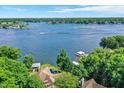 Expansive lakefront property showcasing serene blue waters and a lush green tree line at 8924 Stormhaven Ct, Indianapolis, IN 46256