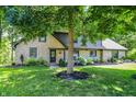 Stunning two-story stone house with well-manicured landscaping and mature trees at 8924 Stormhaven Ct, Indianapolis, IN 46256
