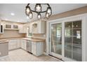 Well-lit kitchen equipped with white cabinets, stainless steel appliances, and a convenient access door at 9189 Dawn Dr, Brownsburg, IN 46112