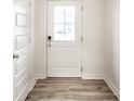 Bright entryway showcases a white front door, wood-look flooring, and neutral-toned walls at 10210 Samerton Ln, Indianapolis, IN 46239