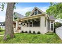 Exterior of this charming home, showcasing a covered porch and well-maintained lawn at 1046 N Hamilton Ave, Indianapolis, IN 46201