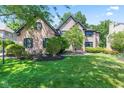 Charming two-story brick house with well-maintained lawn and lush landscaping at 11266 Old Stone Dr, Indianapolis, IN 46236