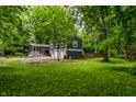 View of two-story home with a screened-in porch and a green lawn at 1515 Randall Rd, Indianapolis, IN 46240