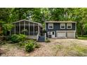Charming two-story home with screened-in porch and landscaped yard at 1515 Randall Rd, Indianapolis, IN 46240