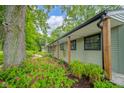 A beautiful home exterior is landscaped with vibrant flowers and green foliage at 1605 Westlane Rd, Indianapolis, IN 46260