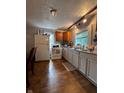 Bright kitchen with plenty of storage, laminate flooring, and a window over the sink at 1728 N Somerset Ave, Indianapolis, IN 46222