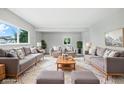 Bright, spacious living room with comfortable seating, a large window, and a plush rug at 1933 Tallman Ave, Indianapolis, IN 46218