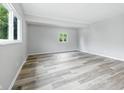 Open living area featuring neutral walls, luxury vinyl plank flooring, and ample natural light at 1933 Tallman Ave, Indianapolis, IN 46218