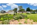 View of the backyard featuring a shed, a garden area with a decorative fence, and lush greenery, ideal for gardening at 202 Collier St, Columbus, IN 47201