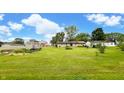 Expansive backyard showcasing a well-kept lawn, perfect for outdoor activities, along with a shed and garden area at 202 Collier St, Columbus, IN 47201