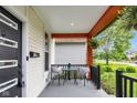 Relaxing front porch view with outdoor seating, hanging plants, and great curb appeal at 3035 Guilford Ave, Indianapolis, IN 46205